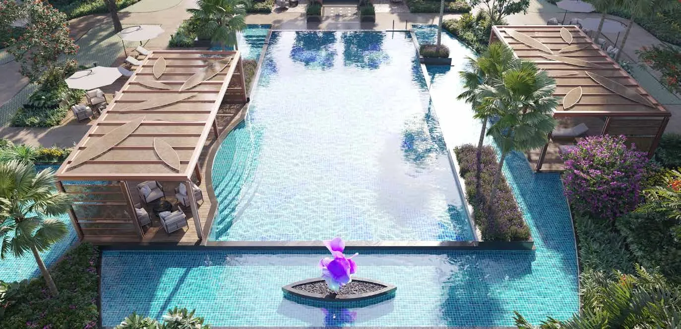 The swimming pool with poolside cabanas and a sculptural orchid fountain.